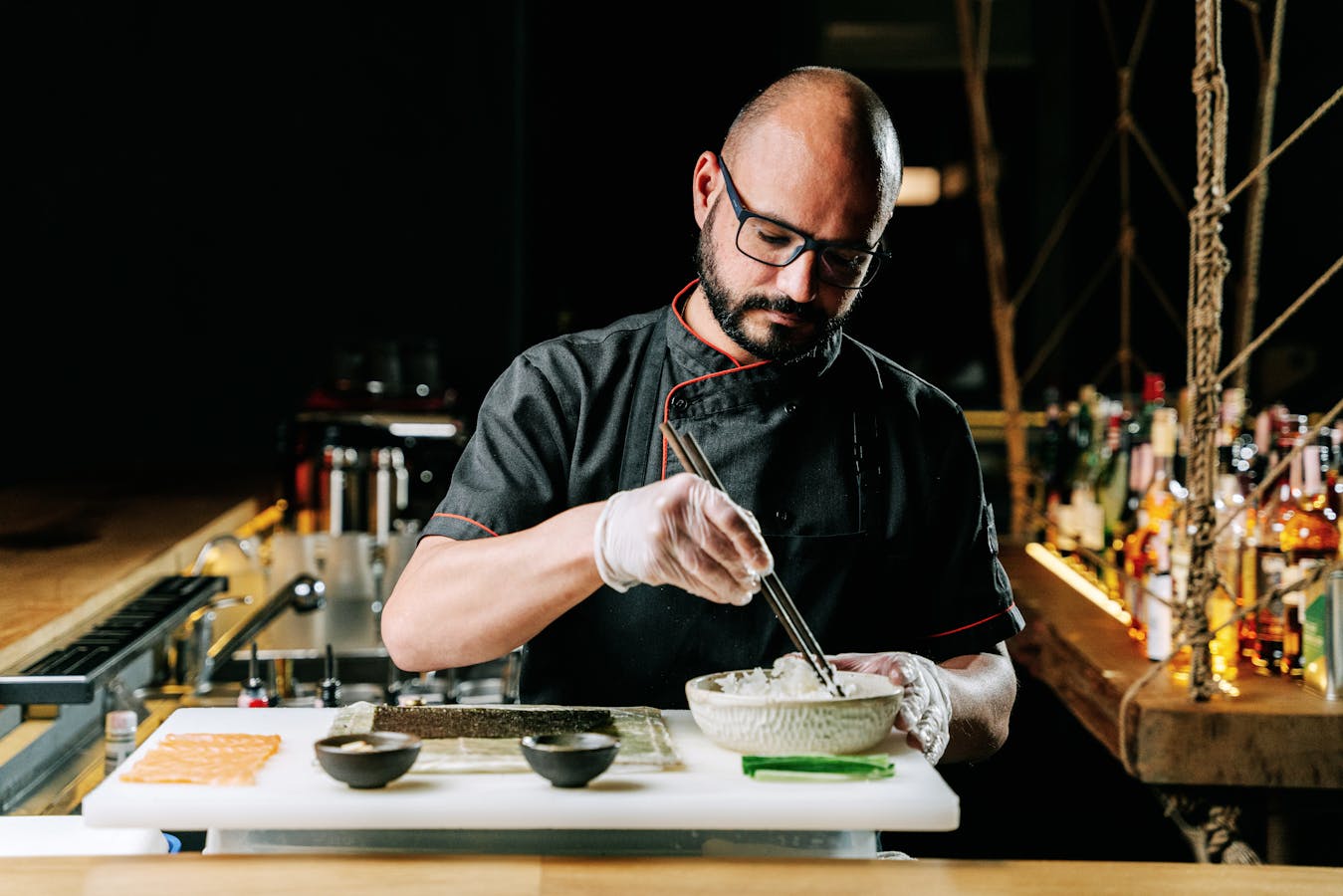 Skilled sushi chef preparing nigiri at counter - best sushi Osaka guide