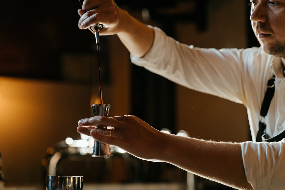 Osaka nightlife bartender crafting a cocktail in a dimly lit bar