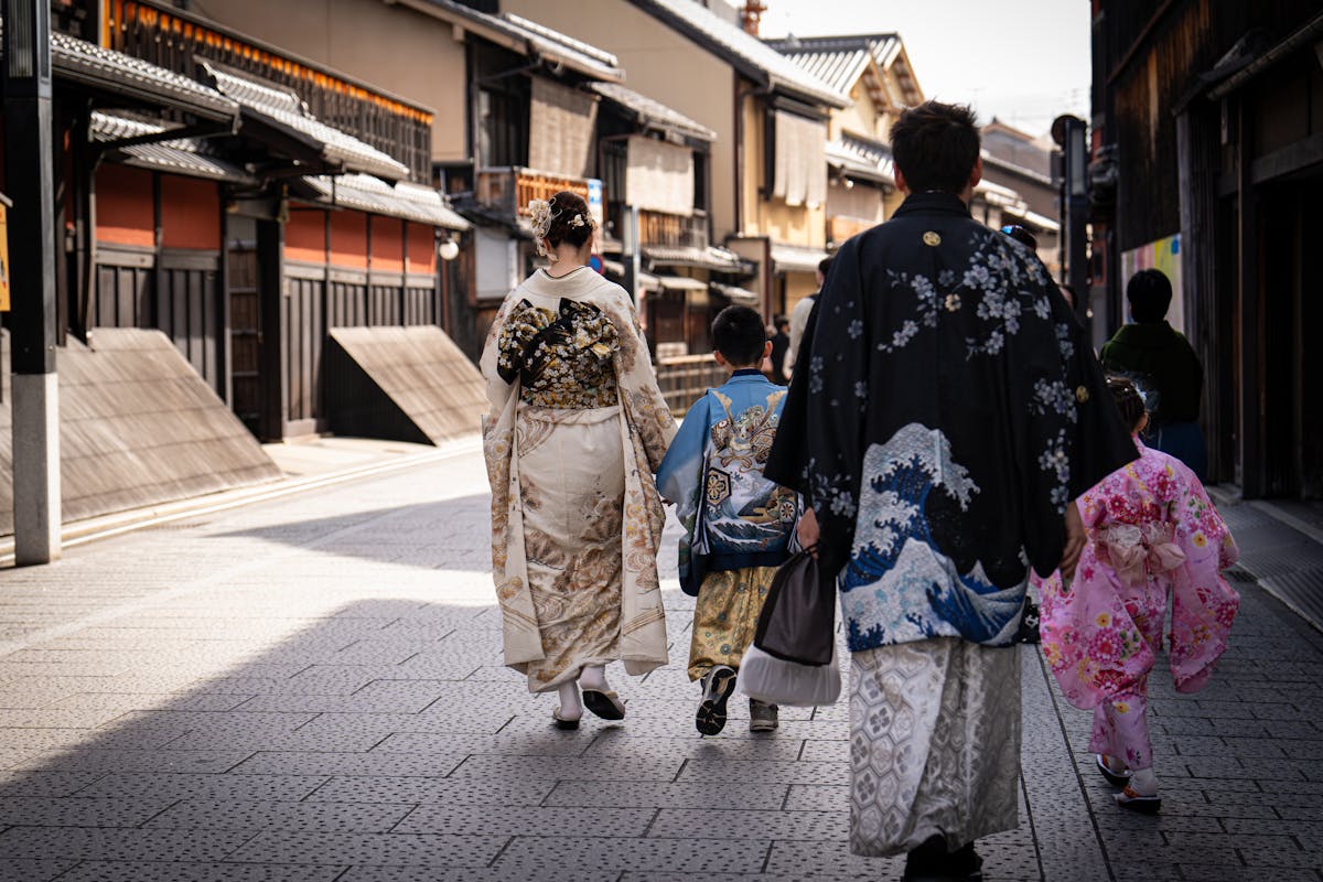 Osaka with kids family wearing colorful kimonos walking through a historic Japanese street