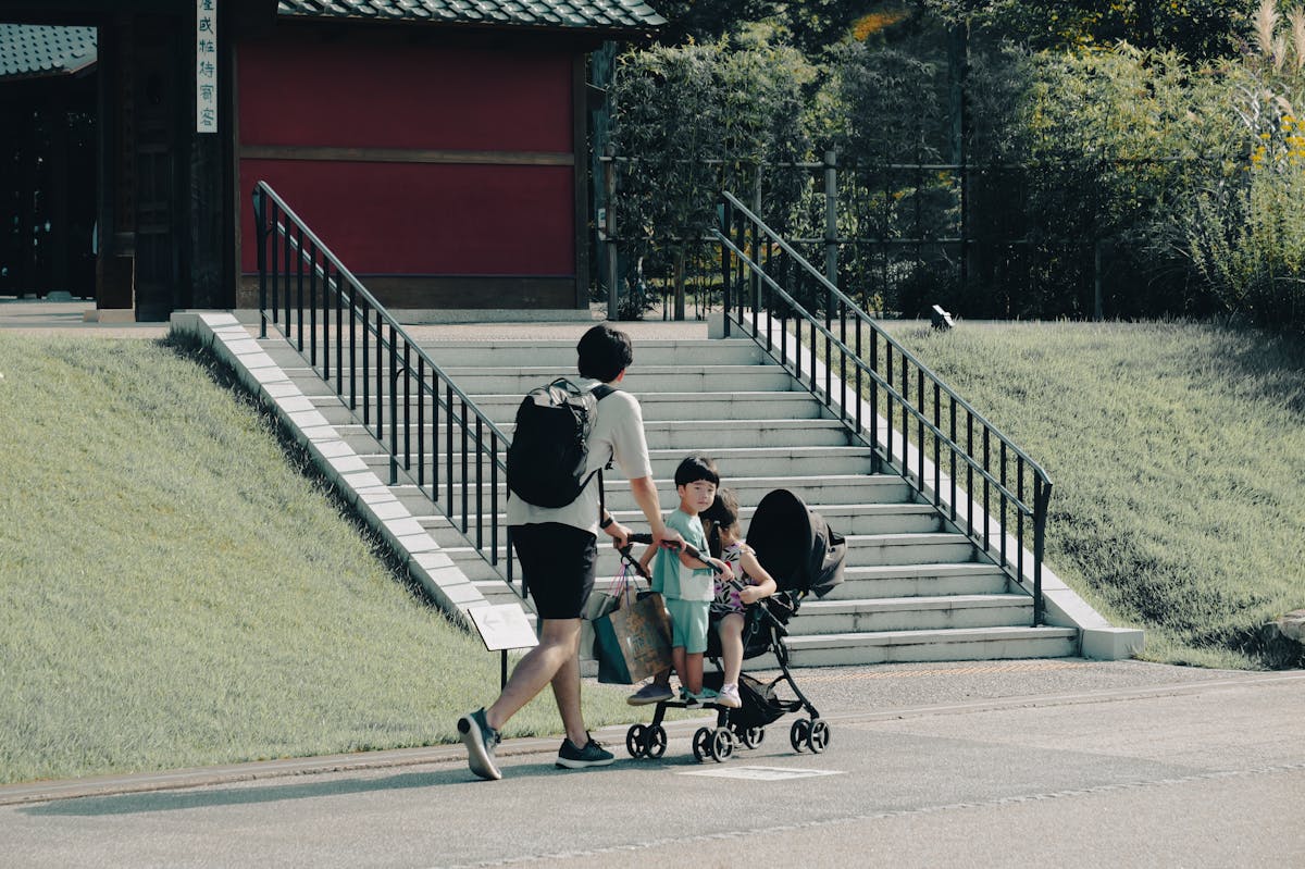 Osaka with kids family with stroller walking on a sunny day in Japan