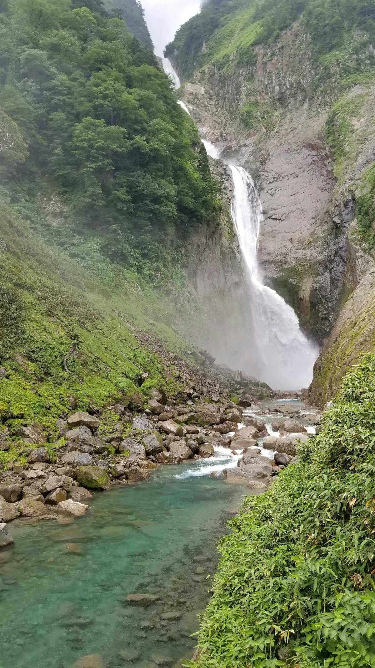 Japanese waterfall cascading through lush valley — nature day trip from Osaka