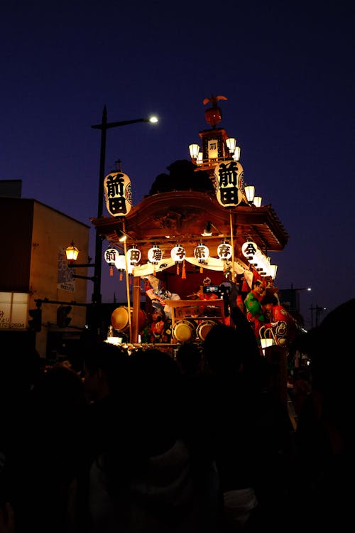 Traditional Japanese festival float glowing at night - festive Osaka cultural experiences