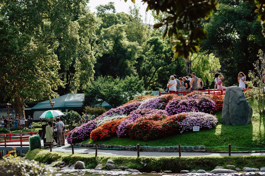 Japanese garden with blooming flowers and visitors - peaceful Osaka hidden gems park
