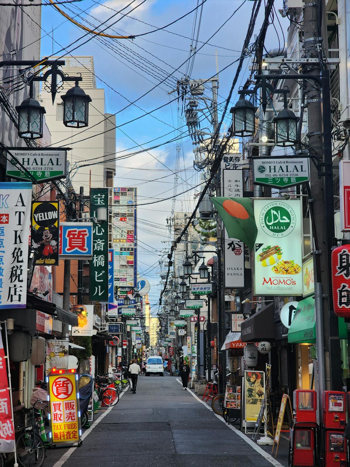 Namba district street in Osaka neighborhood lined with colorful signs and lively shops