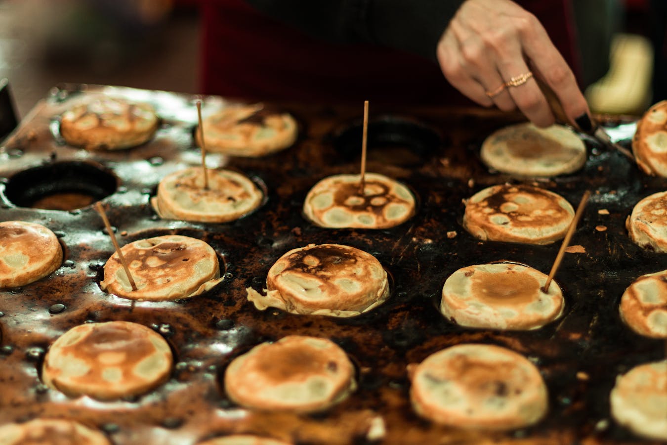 Savory pancakes cooking on griddle - okonomiyaki Osaka