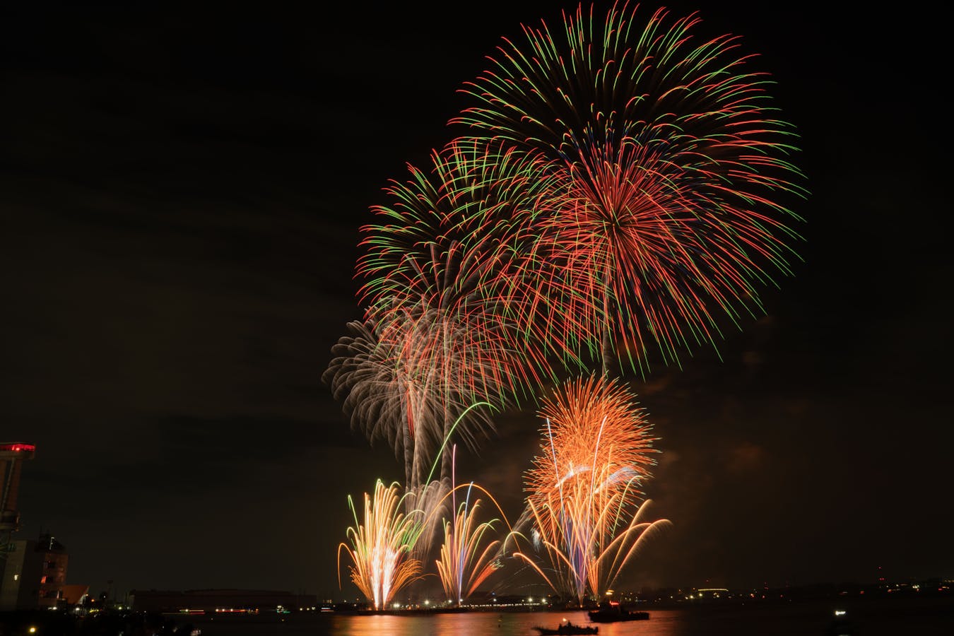 Vibrant fireworks over water - Tenjin Matsuri Osaka festival