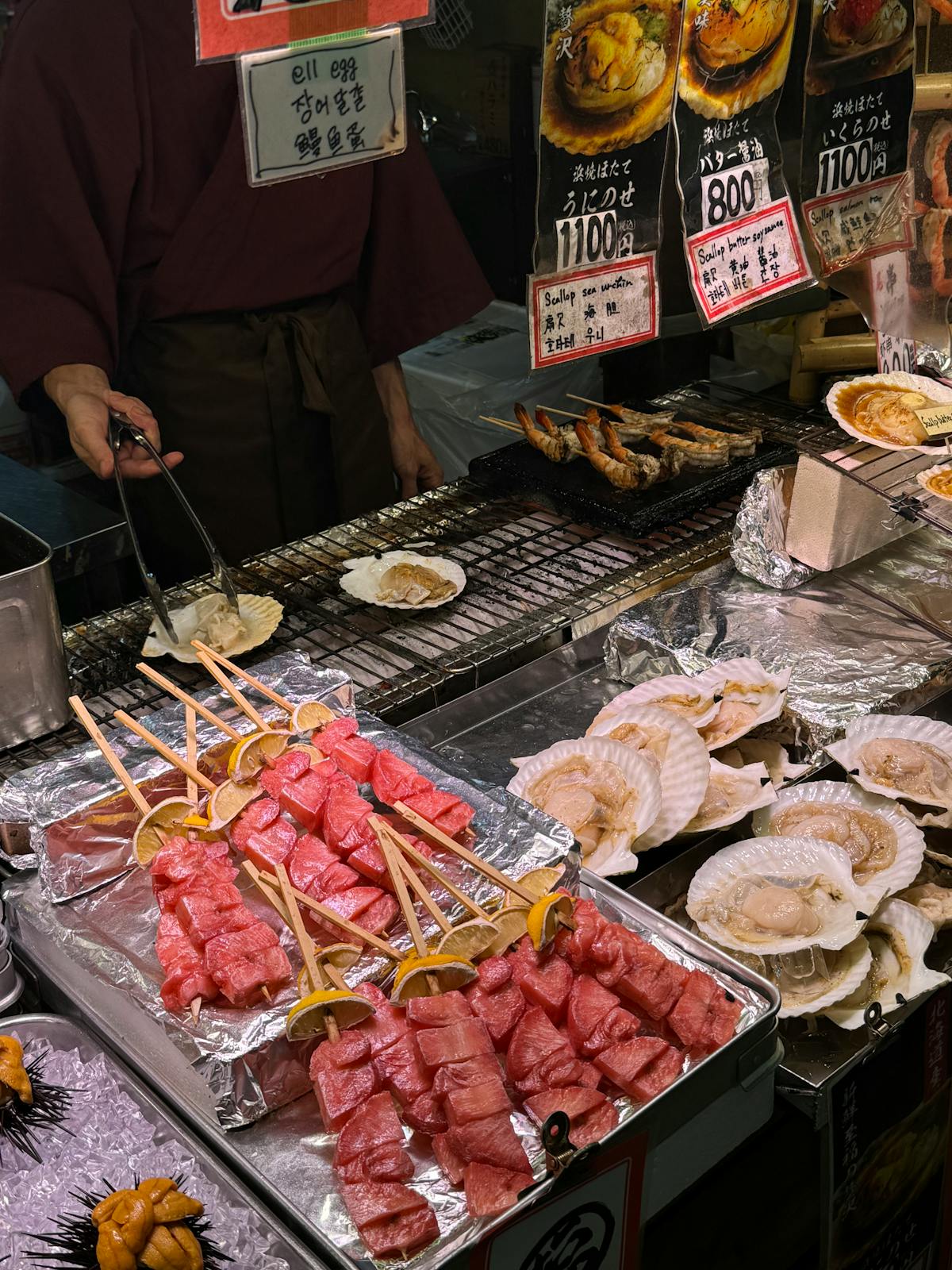 Osaka neighborhood street food stall offering fresh seafood at a vibrant night market
