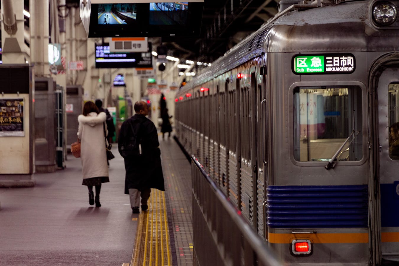 Osaka station platform with commuters - Osaka subway map essential guide