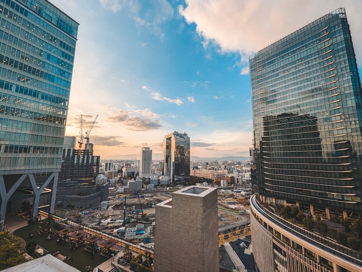 Osaka Umeda neighborhood cityscape and skyline with skyscrapers at sunset