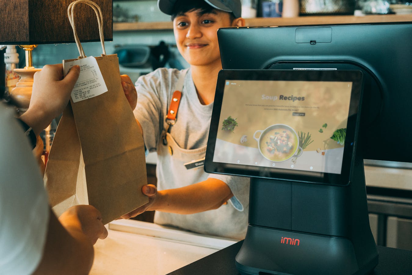 Cashier handing bag to customer - tax free shopping Osaka