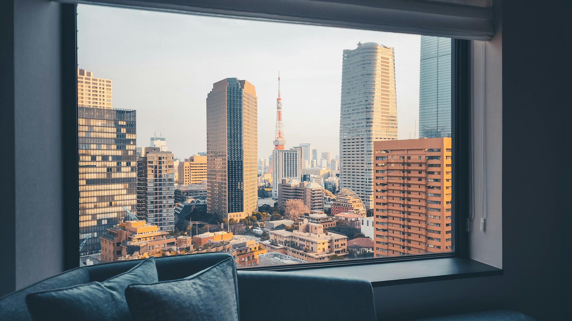 A modern apartment living room with a city view, typical of an Osaka Airbnb rental