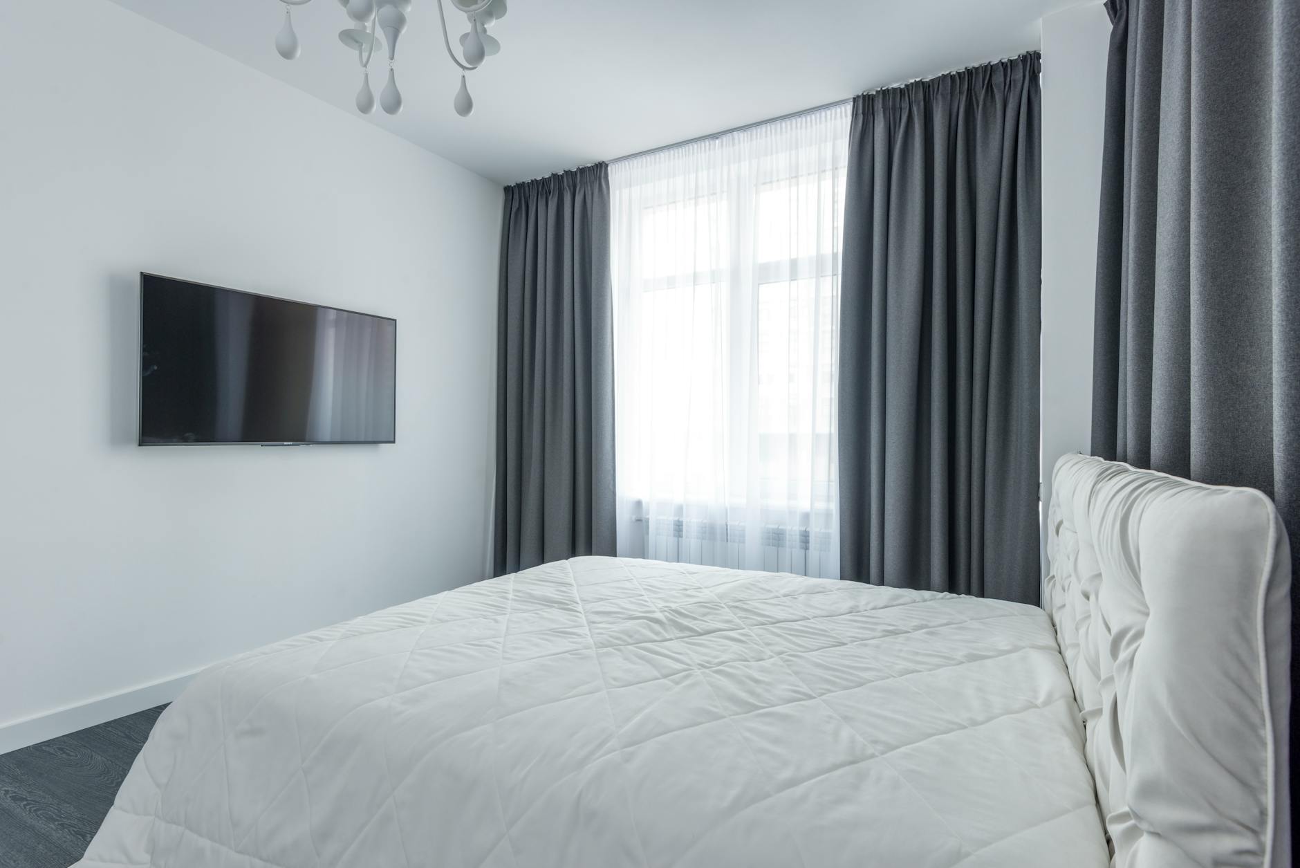 A bright minimalist bedroom with natural light in an Osaka vacation rental