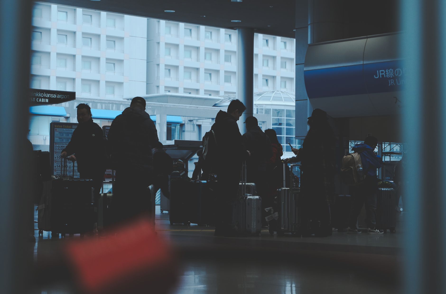 Budget traveller with luggage at an Osaka railway station