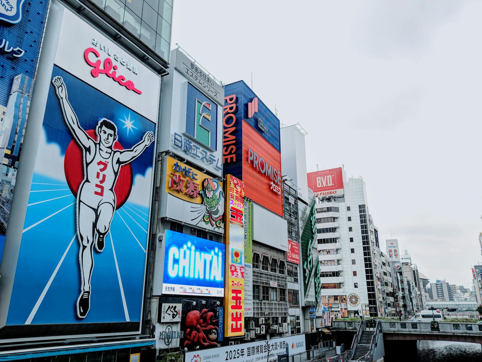 Bright advertising signs including the Glico runner over the Dotonbori Canal in Osaka