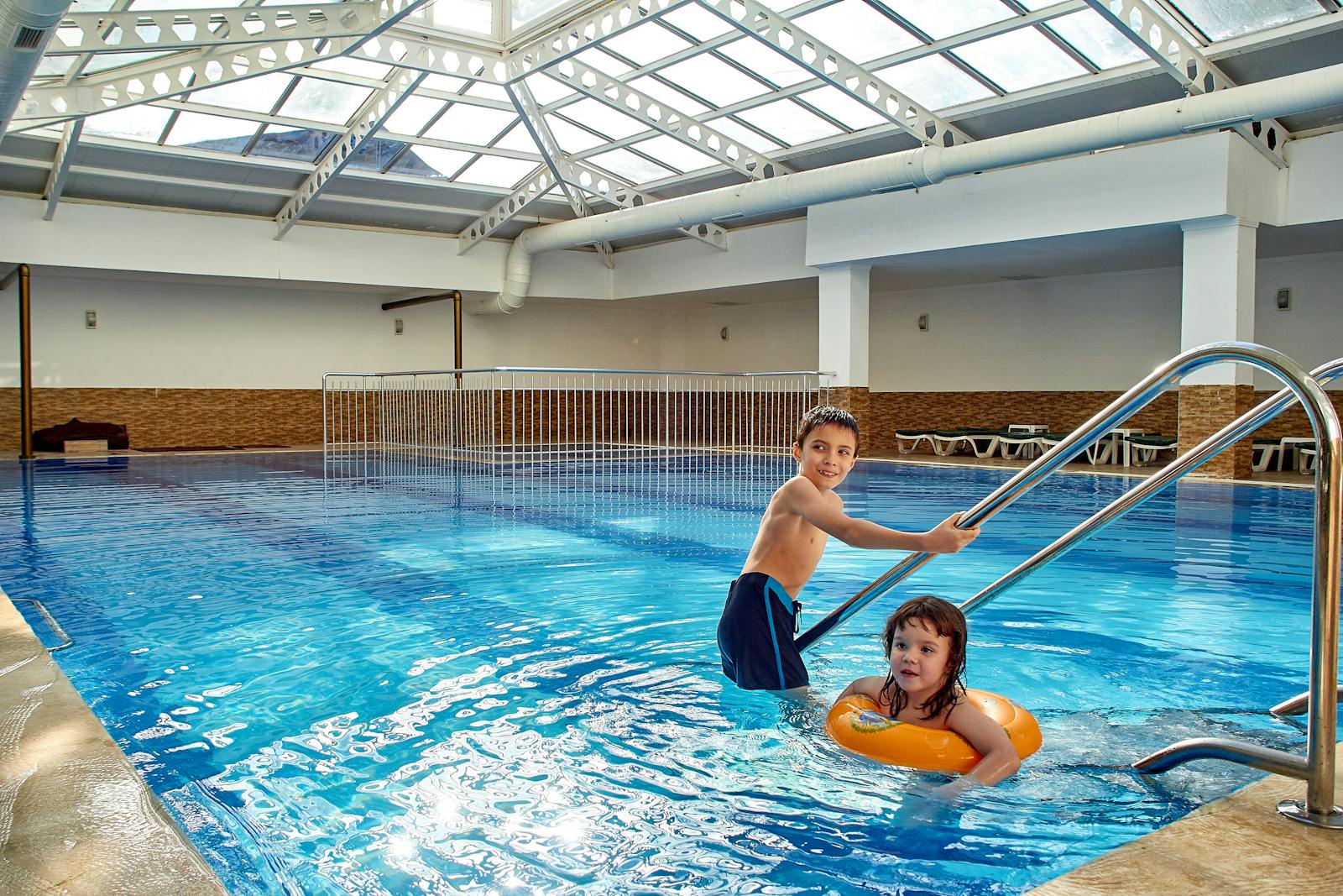 Children swimming in an indoor pool at a family hotel in Osaka