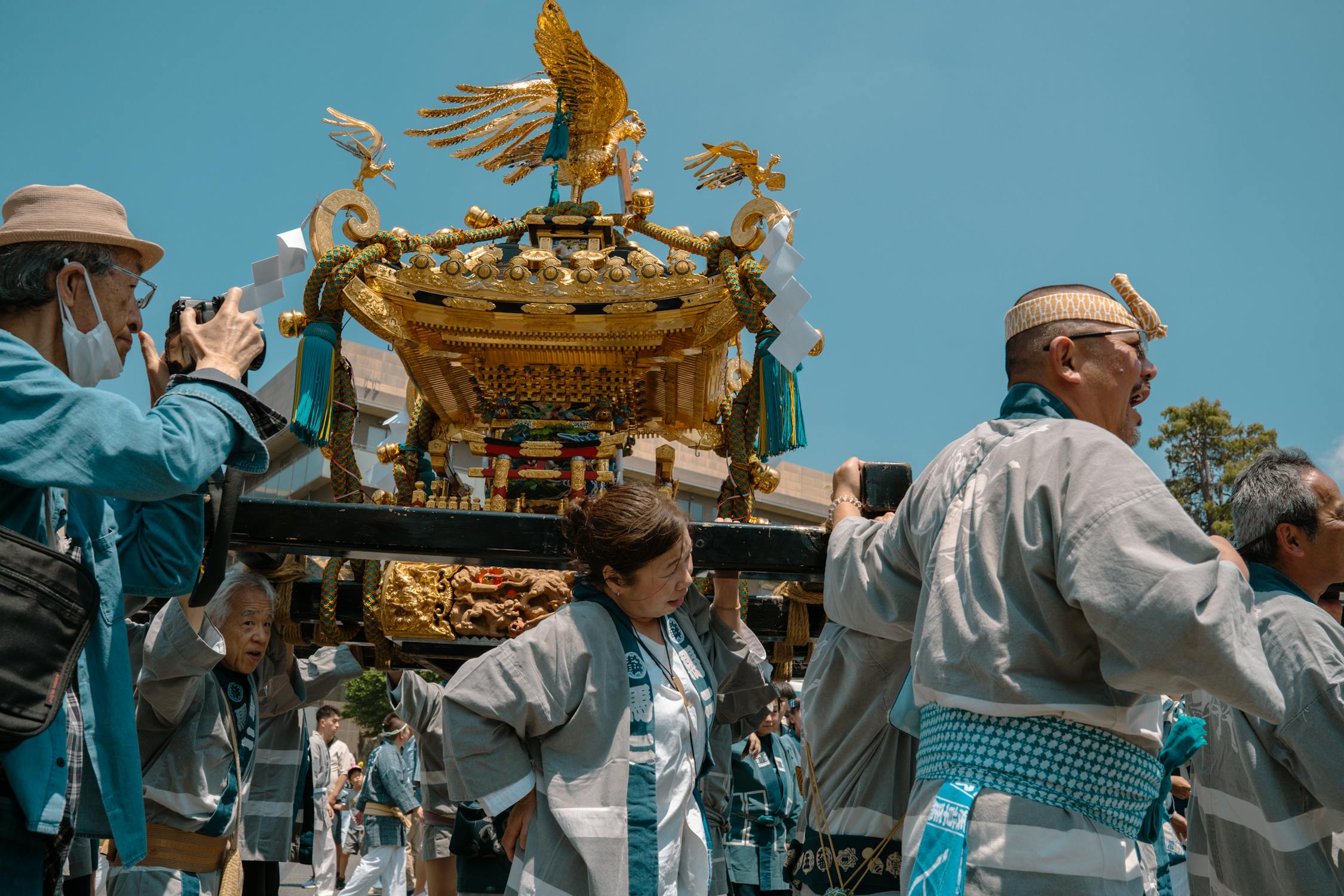 Participants in traditional dress carrying a mikoshi portable shrine during a Japanese festival