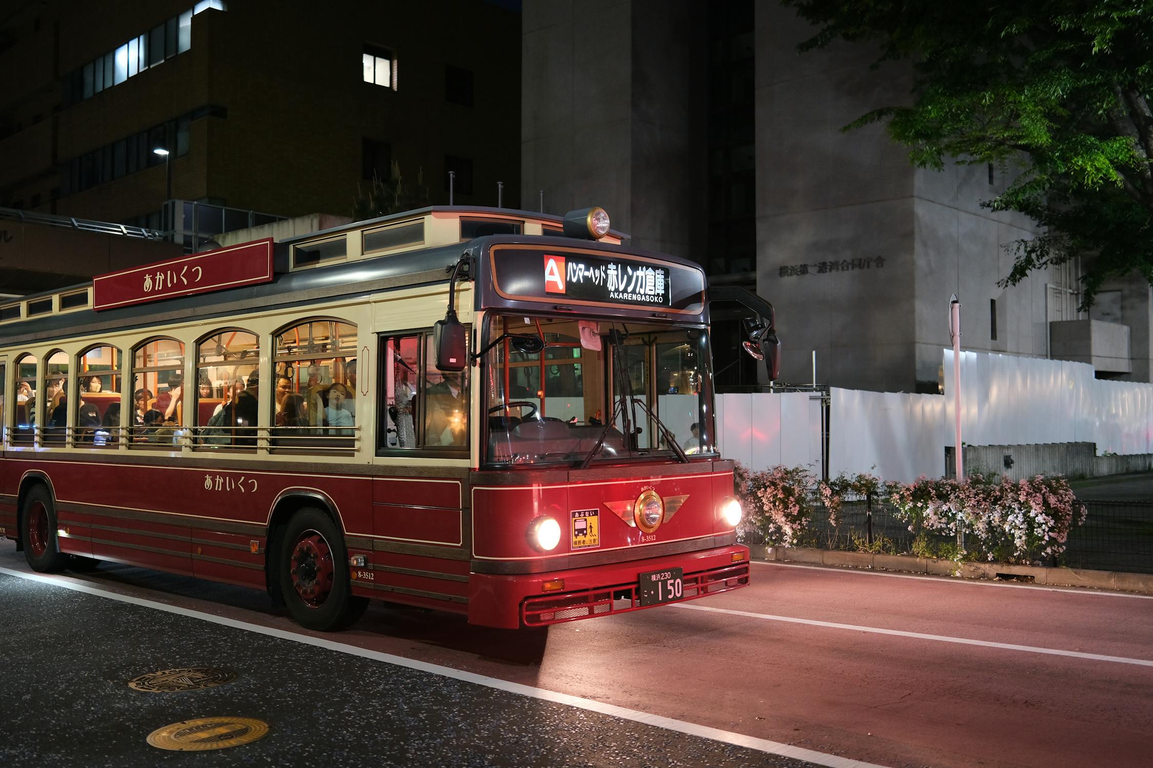 An overnight highway bus lit up at night, the cheapest way to get to Osaka