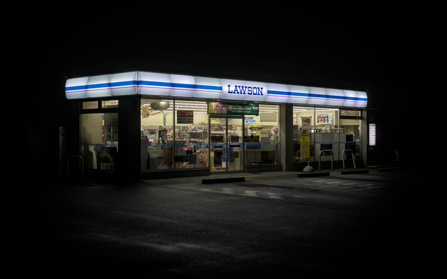 A Lawson convenience store lit up at night in Japan, one of the reliable free WiFi spots in Osaka