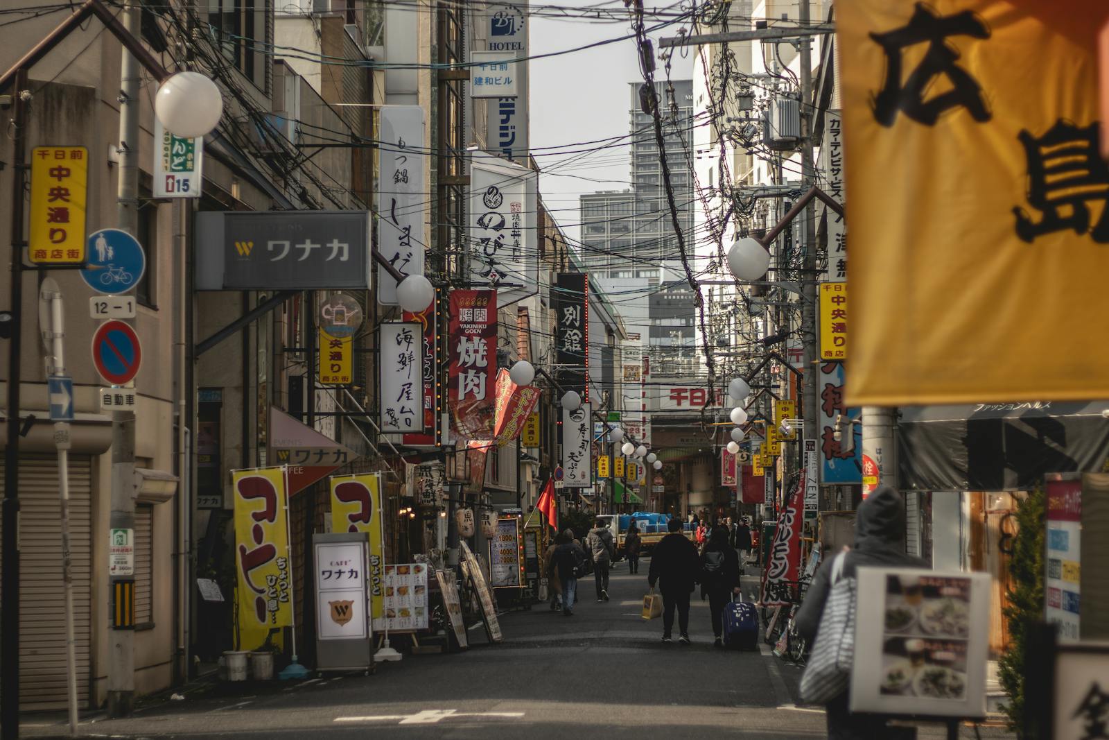 Namba Osaka guide: a busy street in the Namba district lined with shops and signs
