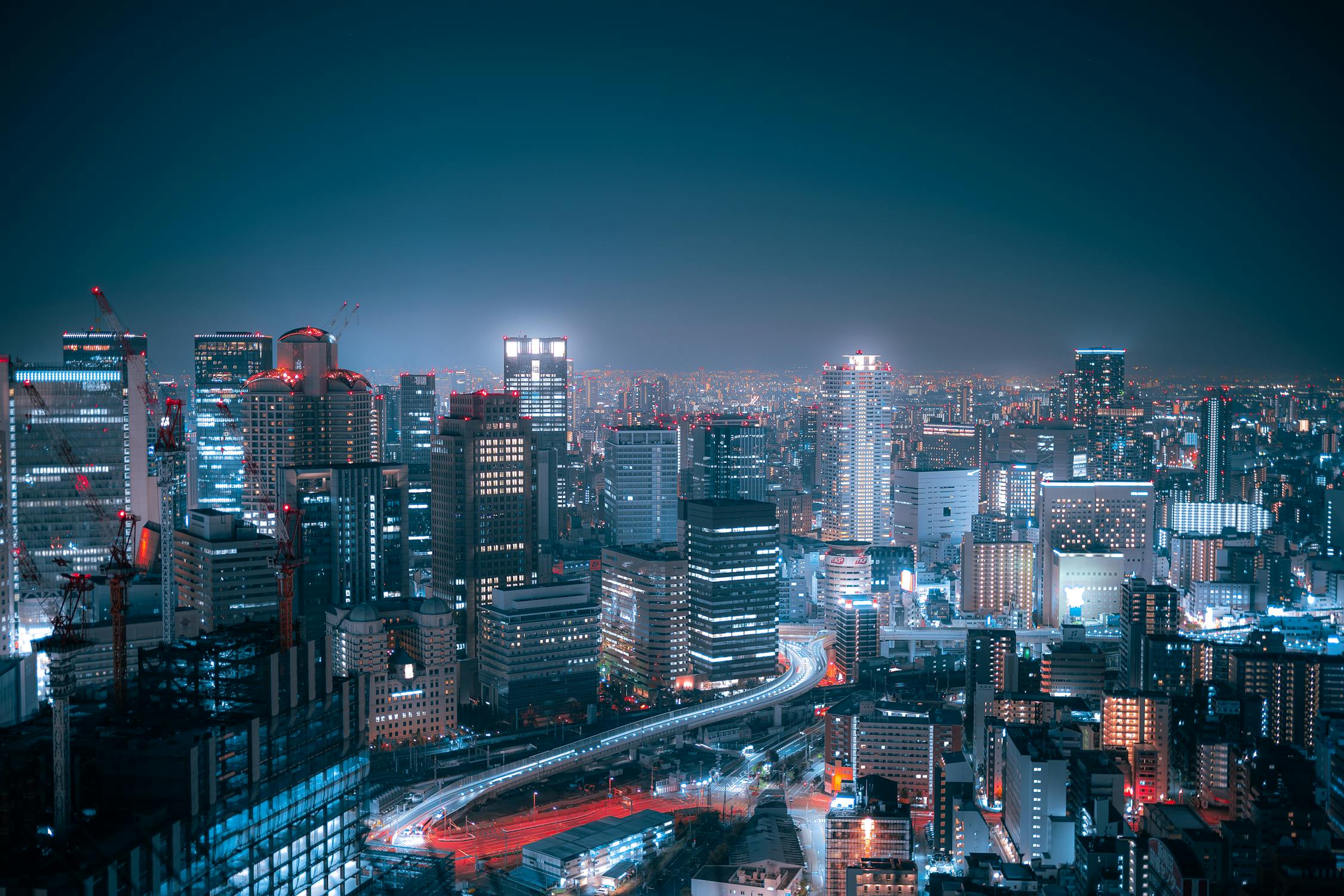 Aerial night view of Osaka city lights from a high observation deck