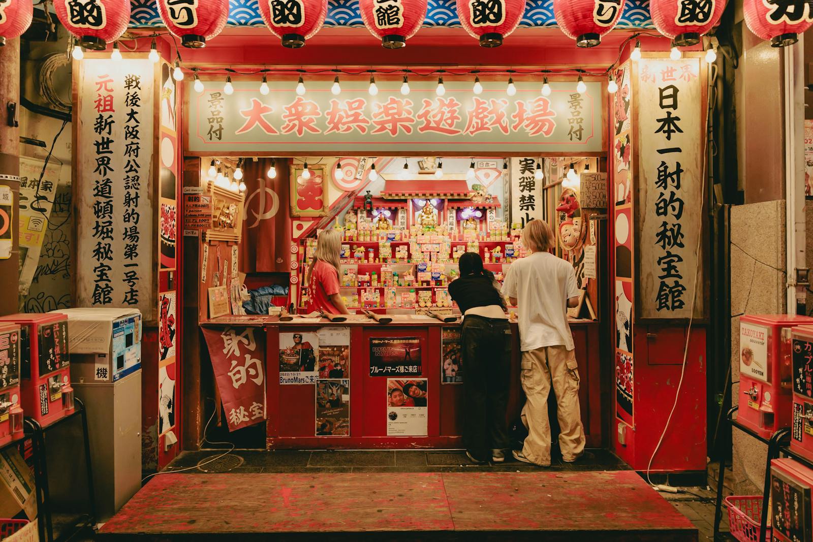 A lantern-lit Japanese arcade stall at night in the Shinsekai area of Osaka
