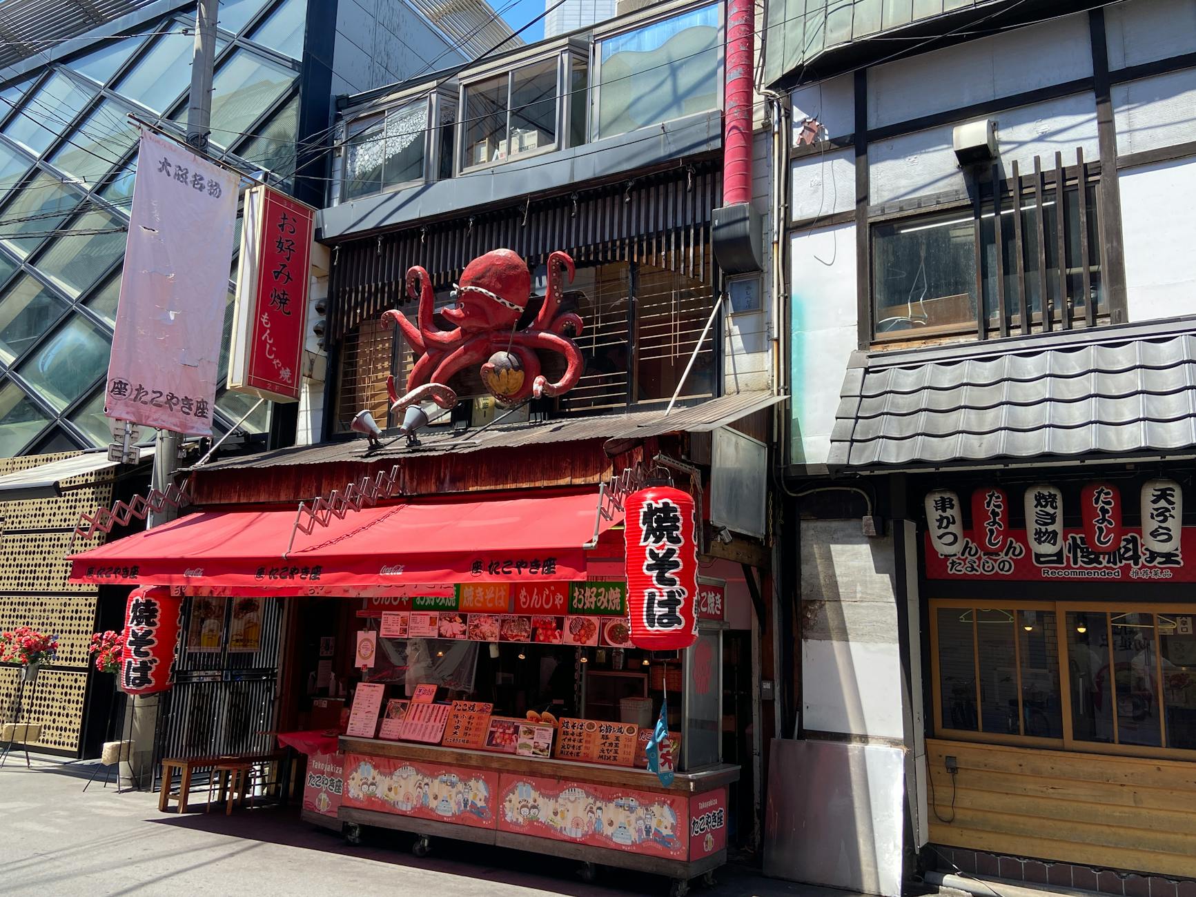 A vendor with fresh octopus at a market stall in Osaka