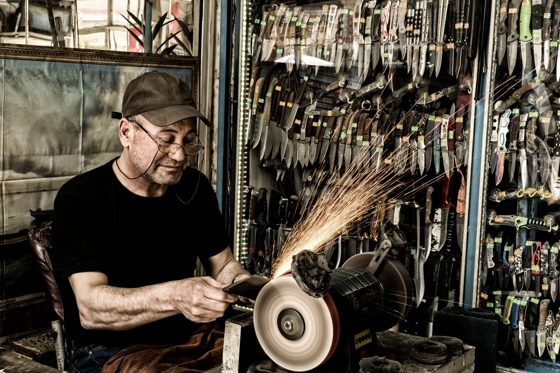 A craftsman sharpening a blade on a whetstone, the hand-finishing step Sakai City Osaka is known for