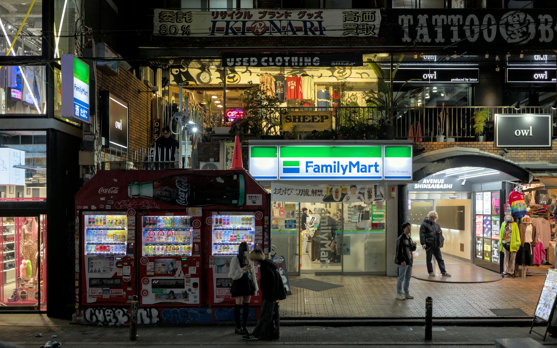 Shinsaibashi-suji arcade lit up at night with shoppers and signage in Osaka