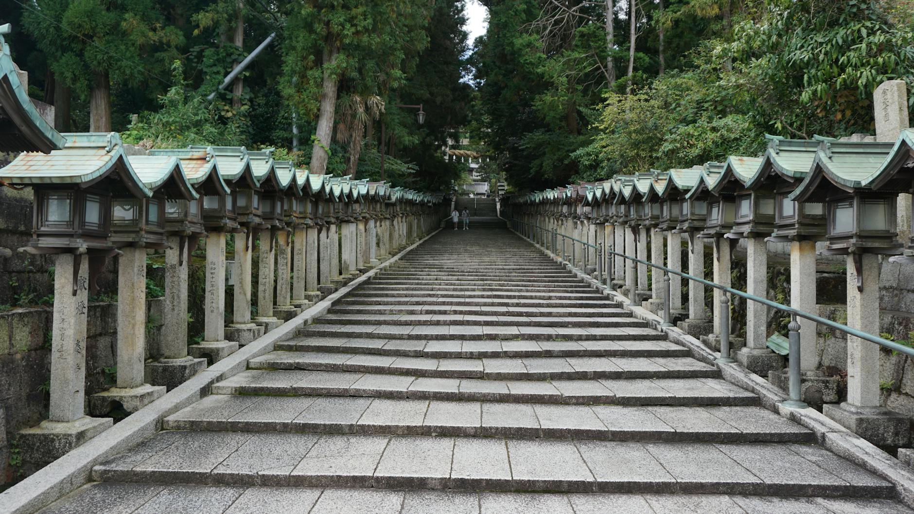 Steps up to a Japanese shrine where visitors remove their shoes, a reason to pack slip-ons for Osaka