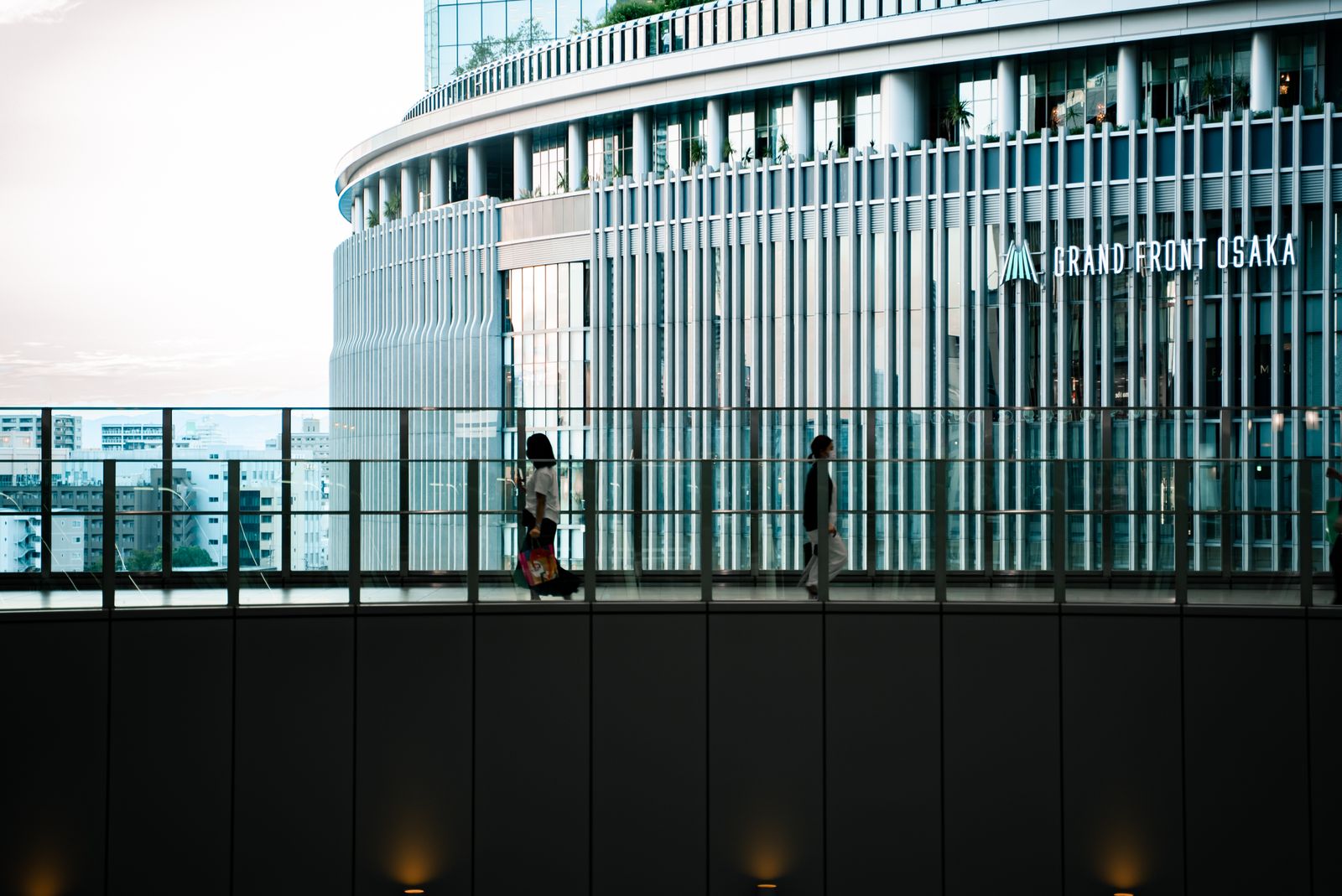 Pedestrians on the elevated walkway beside Grand Front Osaka, which links the complex to Osaka Station