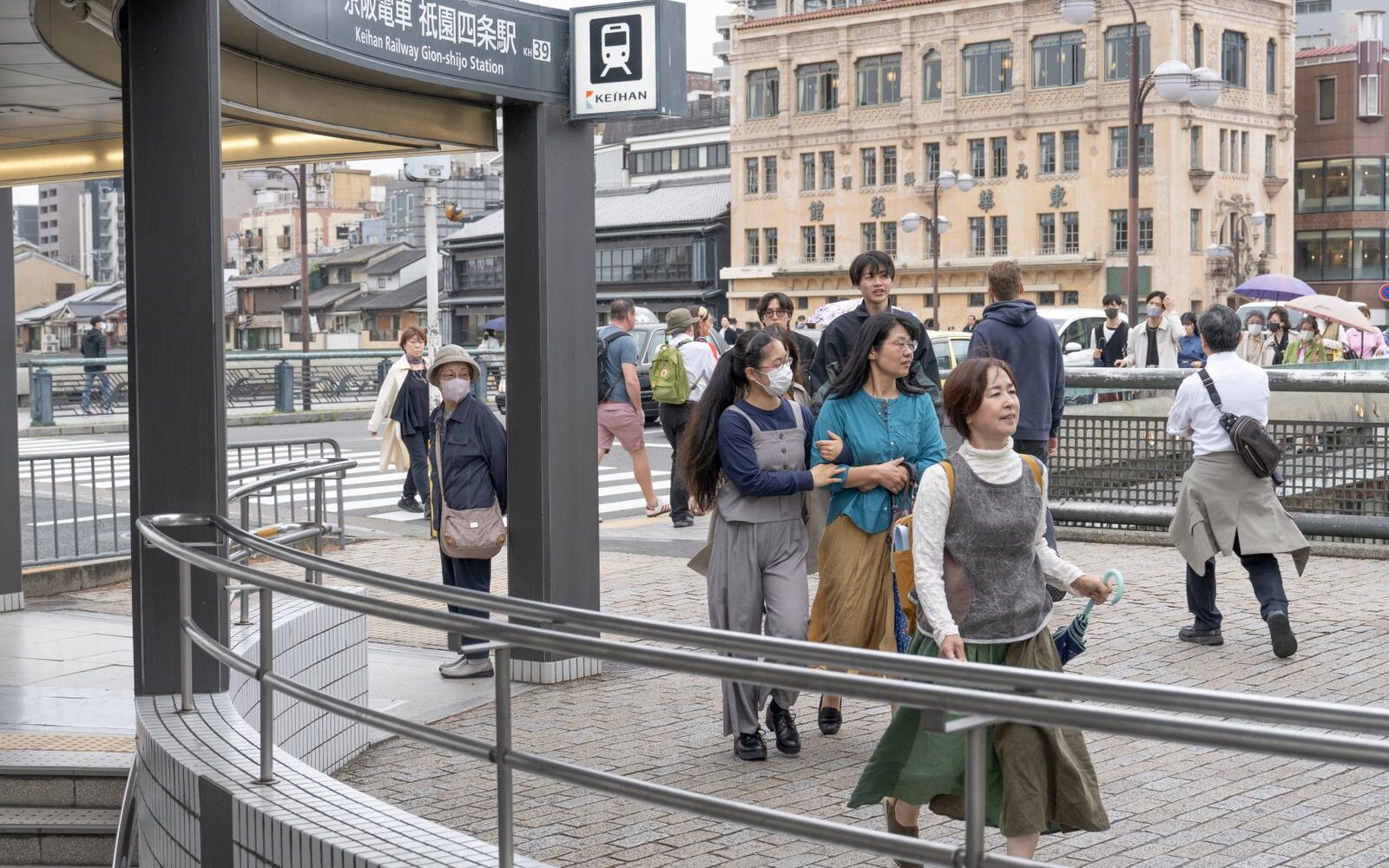 Visitors passing the entrance to Keihan Railway's Gion-Shijo Station in Kyoto