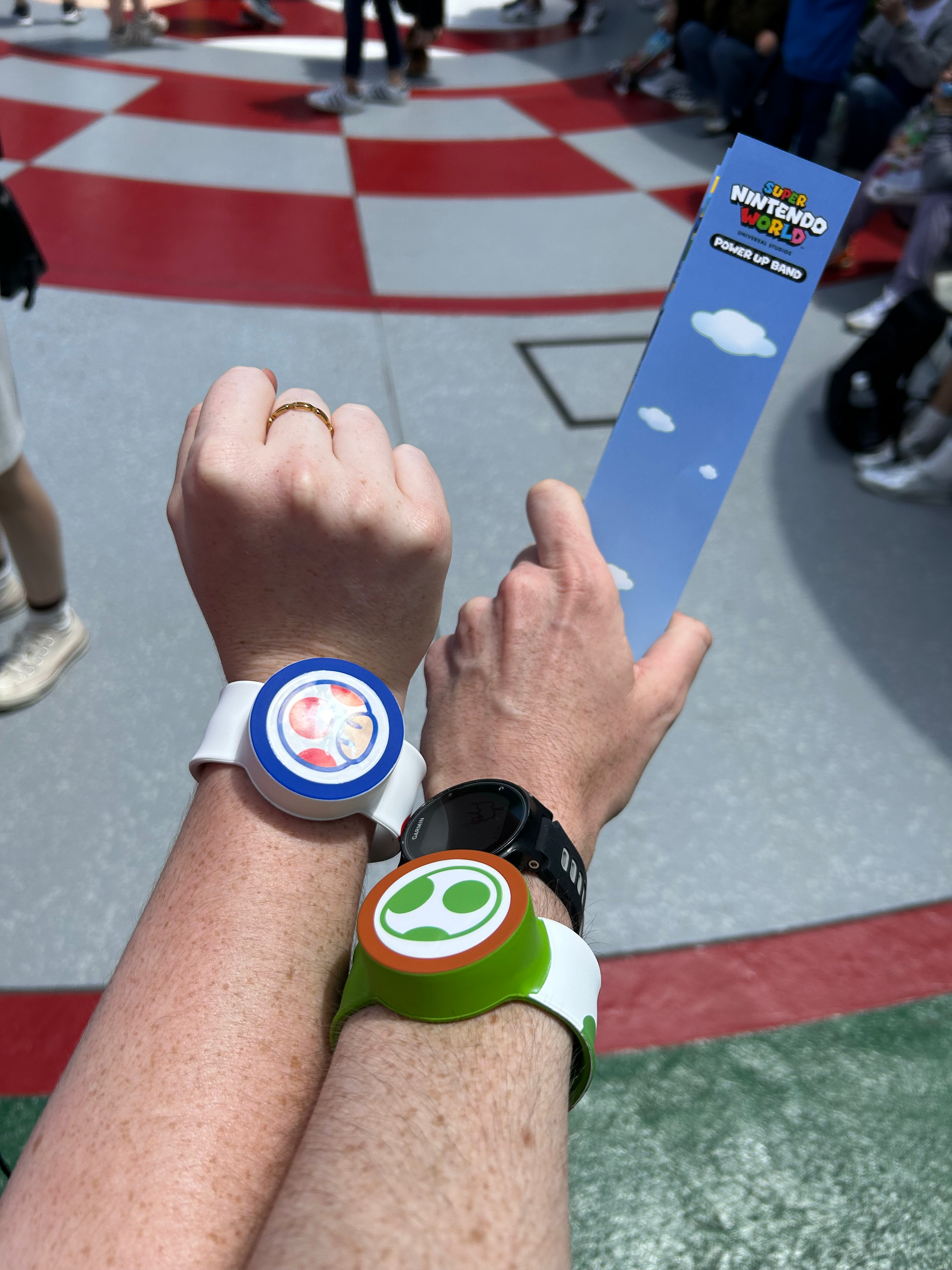 Two visitors wear Toad and Yoshi Power-Up Bands at Super Nintendo World in Universal Studios Japan, Osaka.